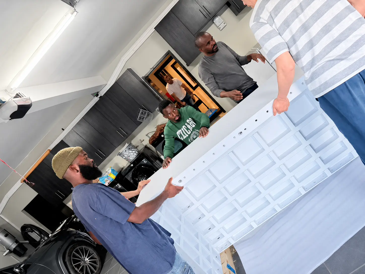 Ueerl chamber modules being handled through a doorway for on-site assembly